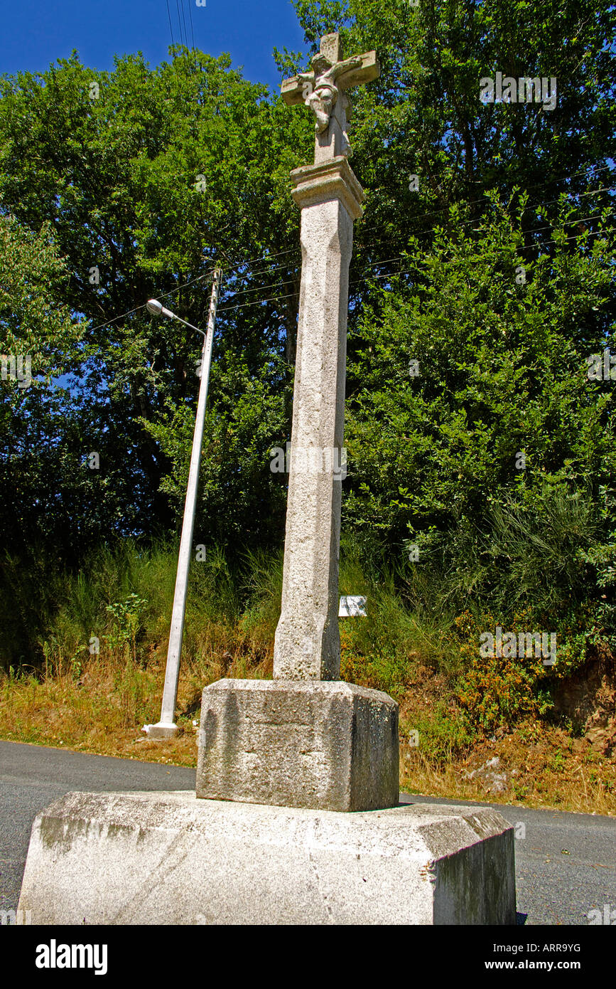 stone cross on a platform with steps and sculpted the crucifix that is placed in the crossing of roads and in the atrium Stock Photo
