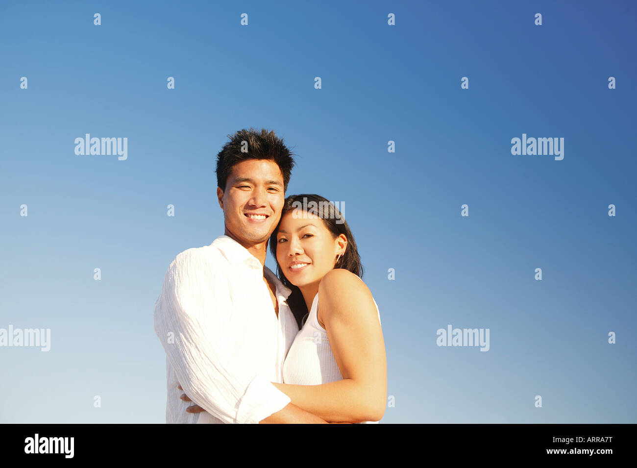 Couple in Front of Blue Sky Stock Photo - Alamy