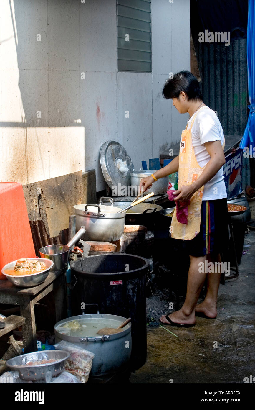 A Cook Cooking In His Makeshift Kitchen Which He Extented To The