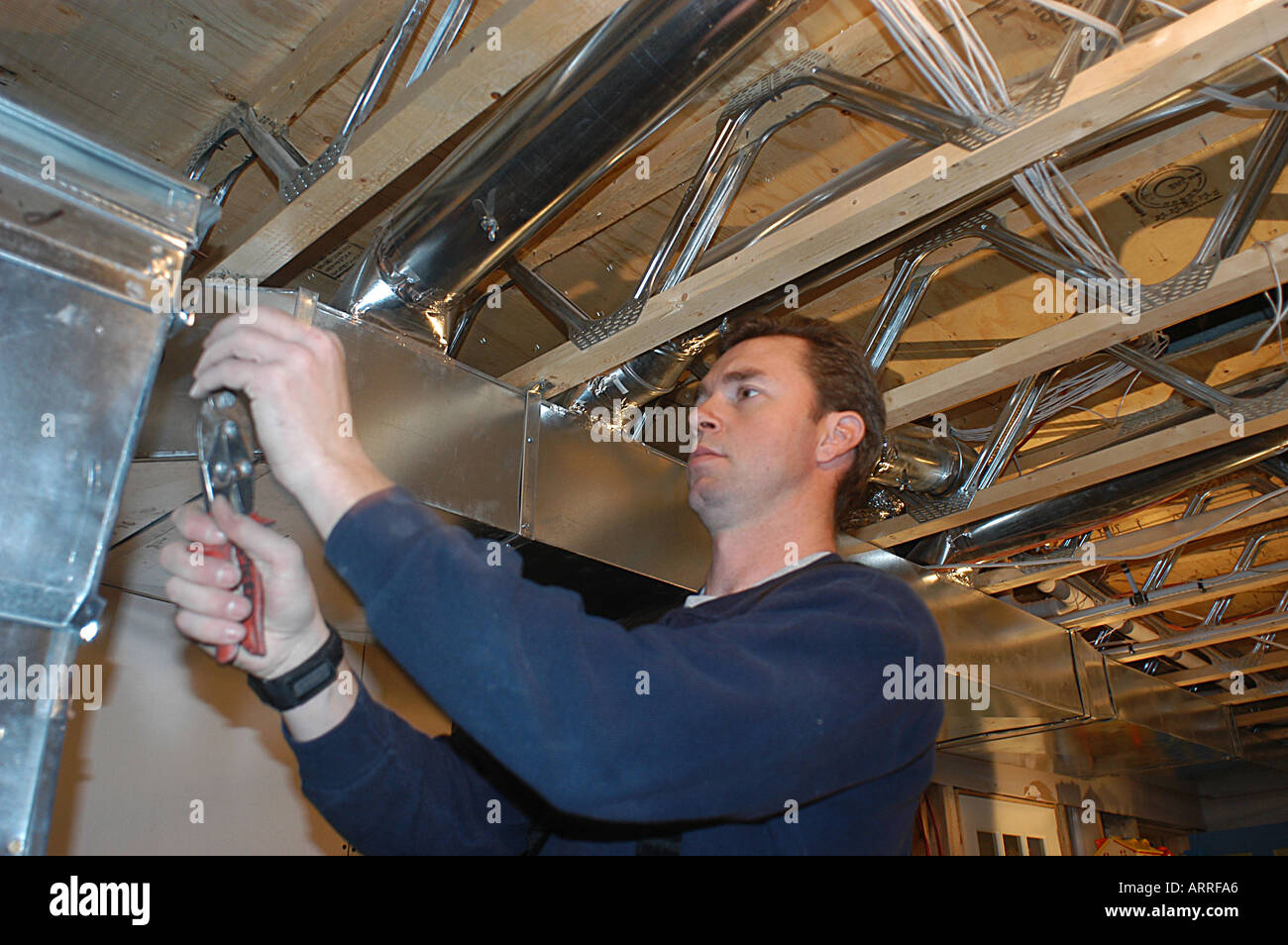 Specialized Technician installing ventilation systems in a house