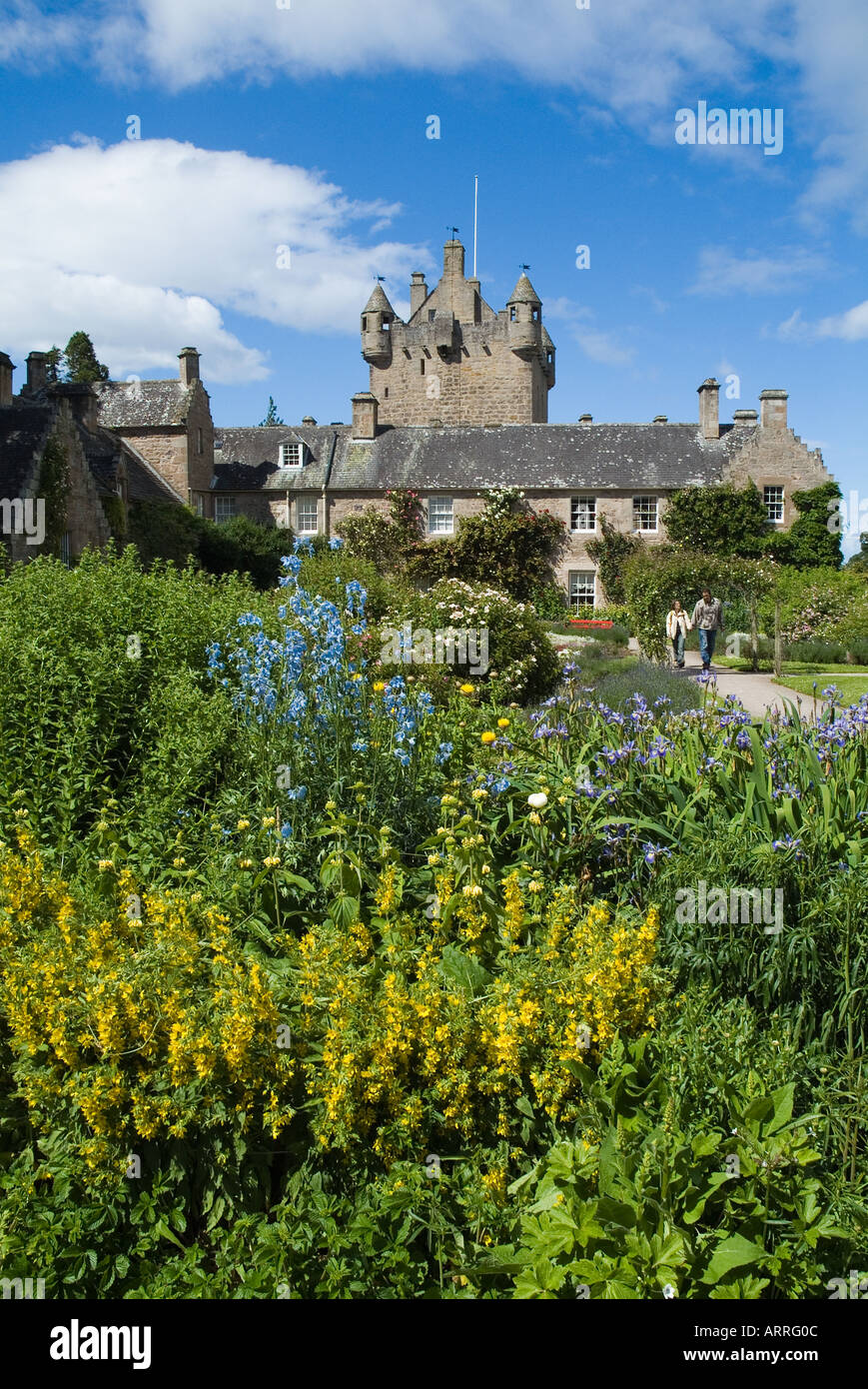 dh Cottage garden CAWDOR CASTLE INVERNESSSHIRE Couple walking in gardens flowers path Tower castles sightseers Scotland Stock Photo
