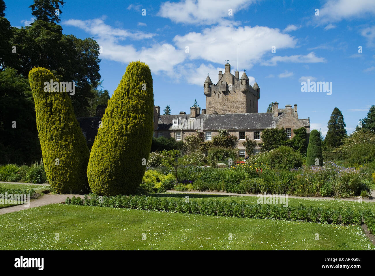 dh Tower house gardens Scotland CAWDOR CASTLE INVERNESSSHIRE Scottish Yew pillars tree hedge cottage garden highlands common taxus baccata uk Stock Photo