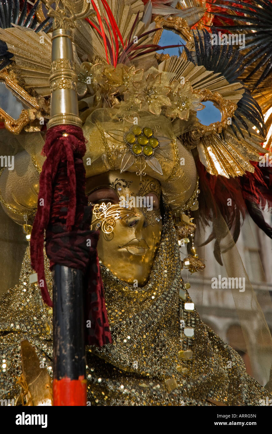Two Carnival Venetian disguises of warrior with golden mask and spear Stock Photo