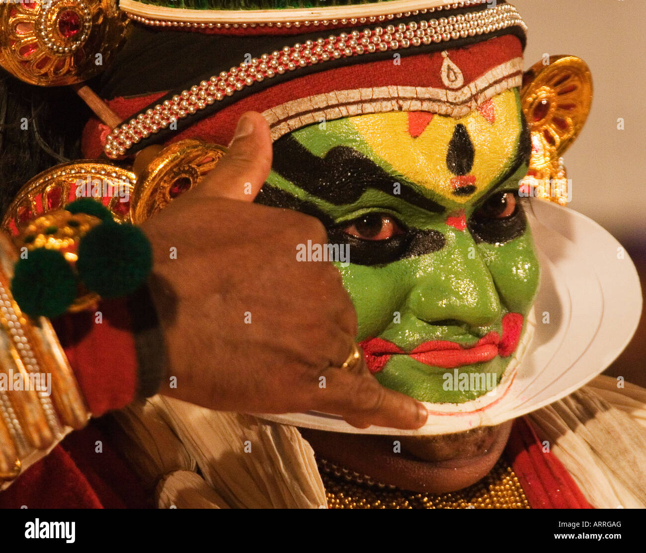 A Kathakali artiste performing Kathakali. Stock Photo