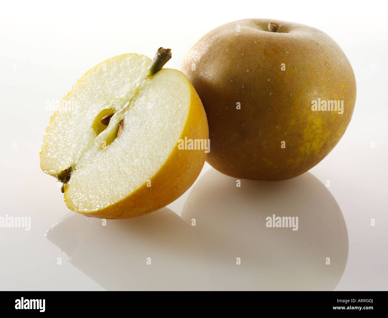 English Russet apple - whole and cut against a white background Stock Photo