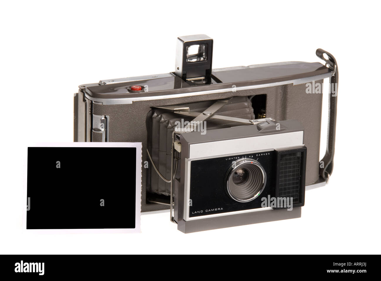 An early 1960s era Polaroid camera spits out a Polaroid print Stock Photo