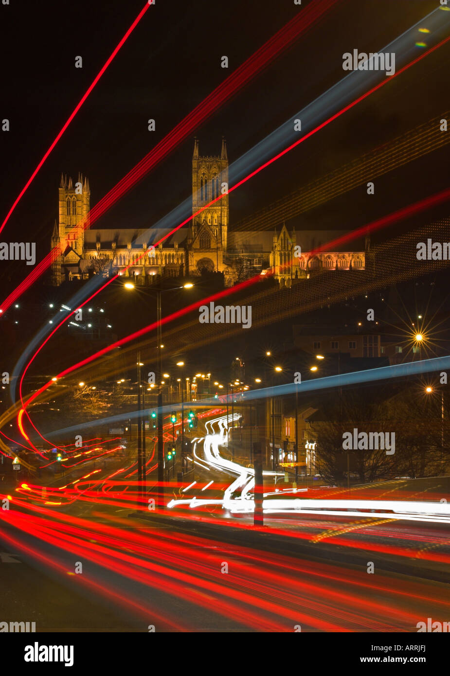 Night shot, traffic trails in Lincoln city, cathedral  in background. Stock Photo