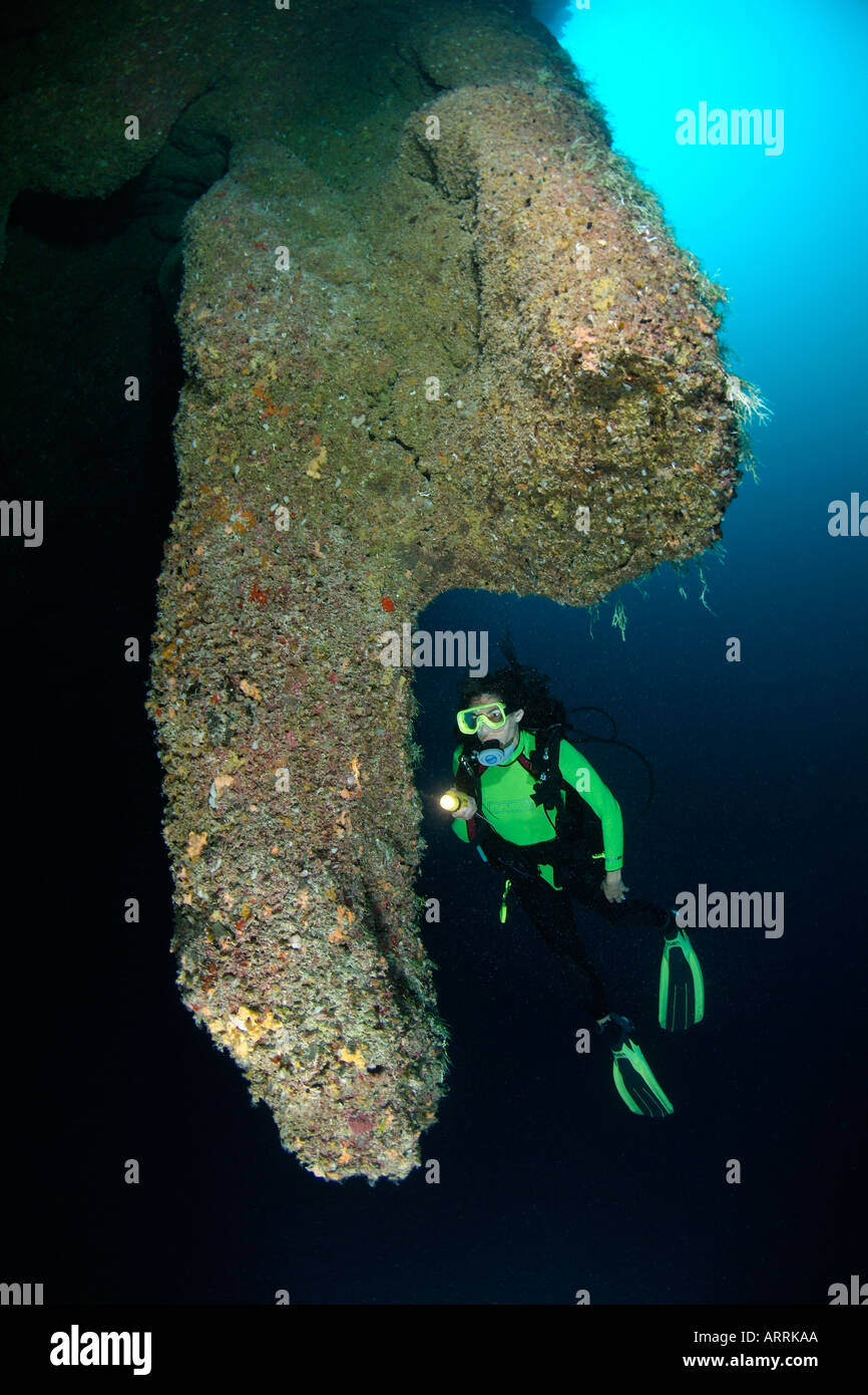 nr0682D. scuba diver, Model Released, explores stalactites130 feet deep in The Blue Hole. Belize. Copyright Brandon Cole Stock Photo