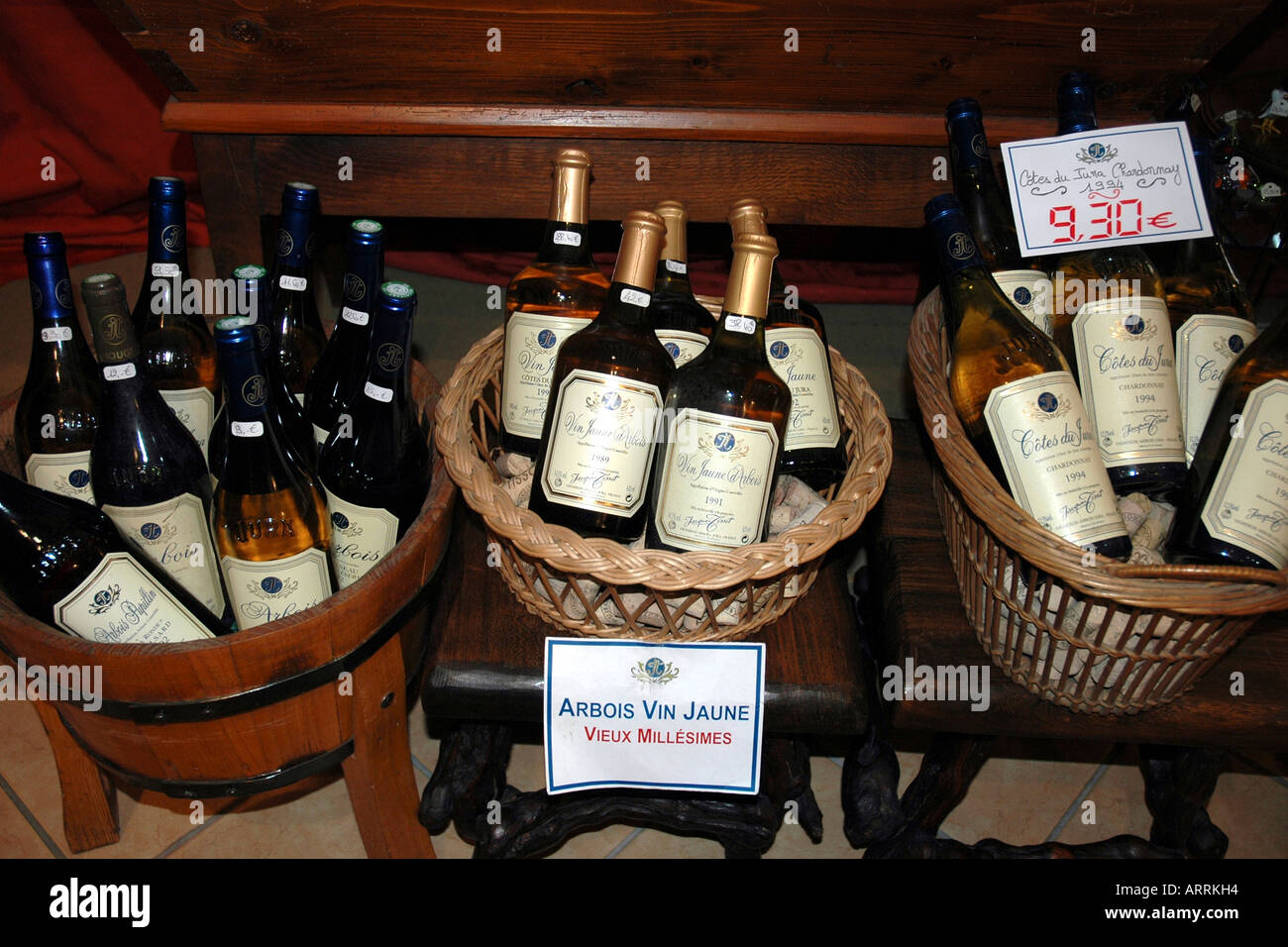 In Arbois, hub of France's winemaking Jura region, a vintner's shop displays wines including vin jaune, a quirky yellow wine Stock Photo