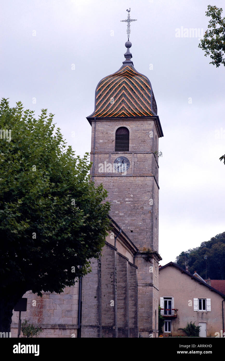 In the Jura winemaking village of Arlay, close to a notable château, is this handsomely tiled belltower Stock Photo