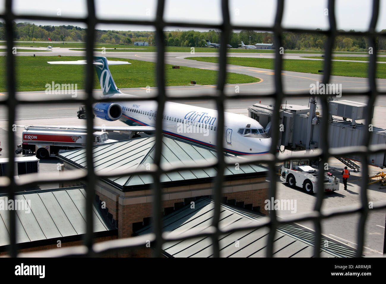 Airplane viewed through a security fence at Westchester County Airport, Harrison, NY Stock Photo