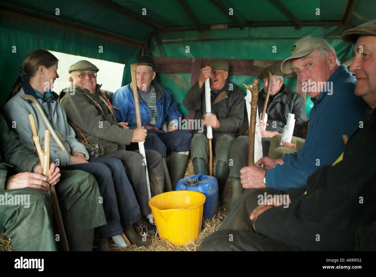Beaters seated on tractor trailer being transported to their beating