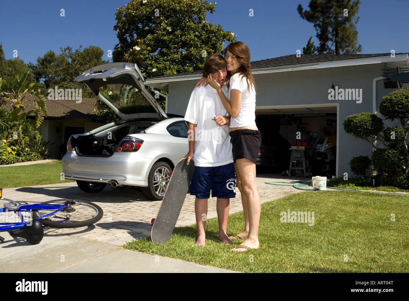 Teenagers goofing off in front yard Stock Photo