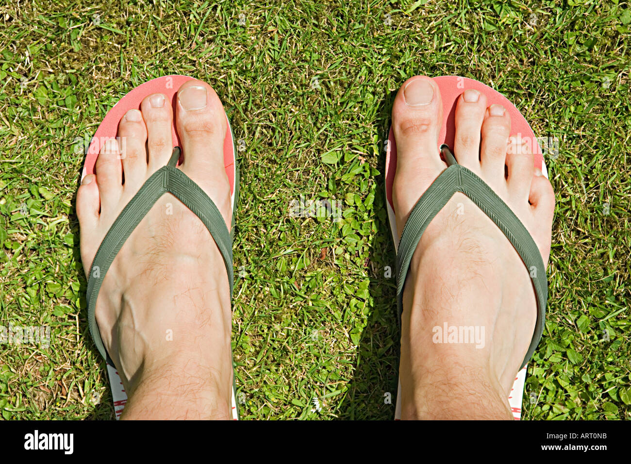 Feet of a man in flip flops Stock Photo