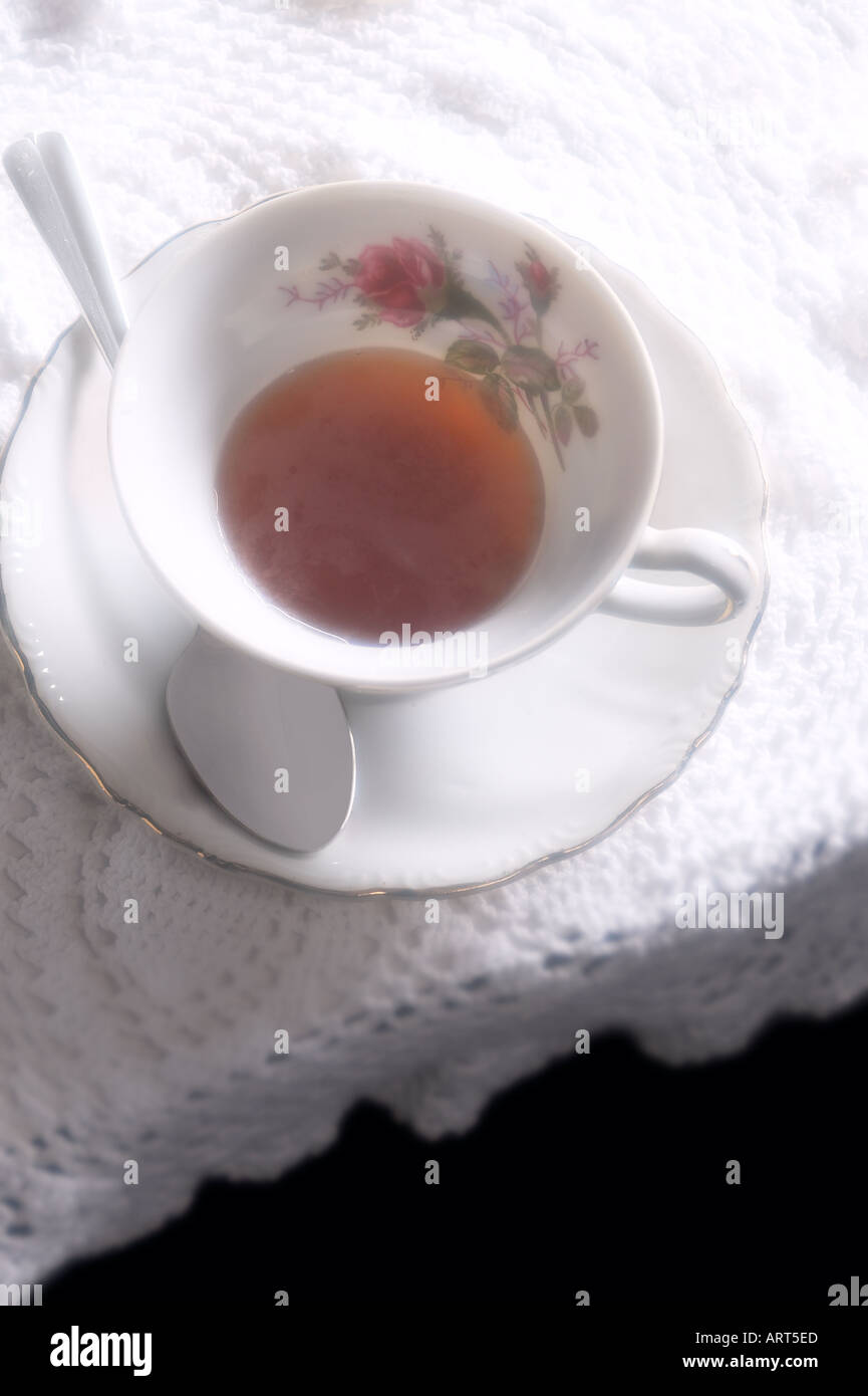 Tea Cup With Spoon On Lace Tablecloth, Aerial View Stock Photo