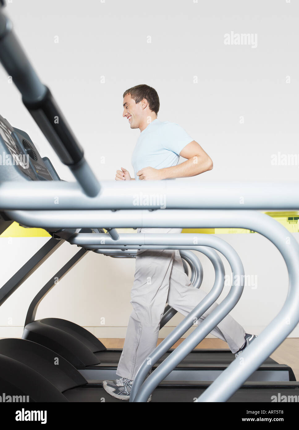 Man on treadmill in health club Stock Photo