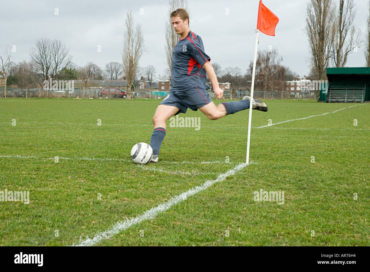 Footballer taking a corner kick Stock Photo