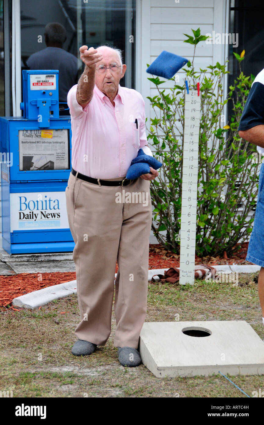 93 year old Senior retired citizen plays game of bean bag toss in a recreational vehicle camping