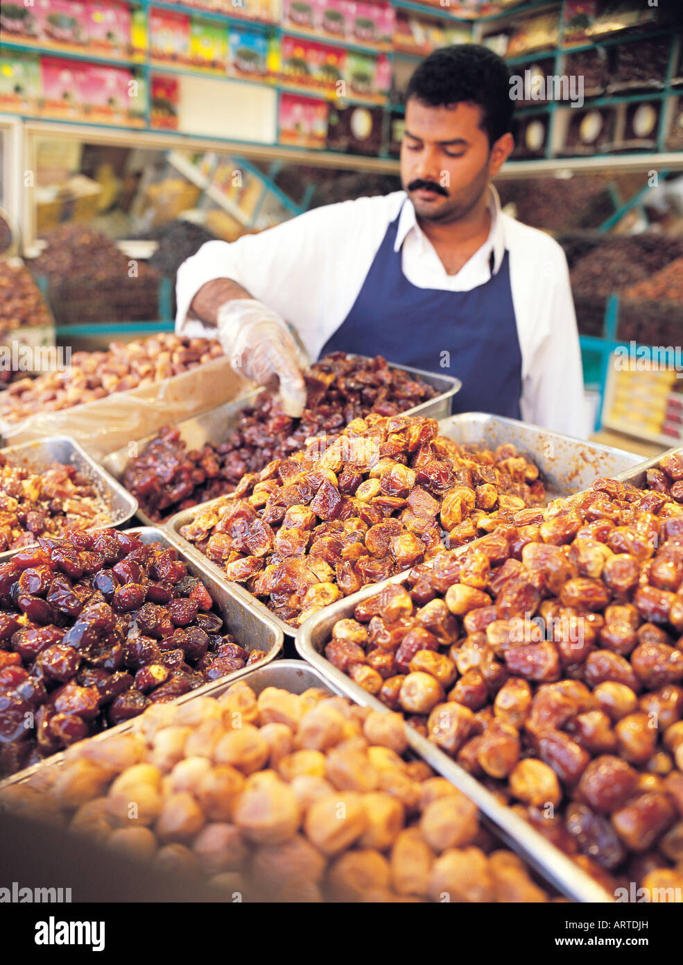 Merchant arranging his dates on display in his shop in Bab Makkah