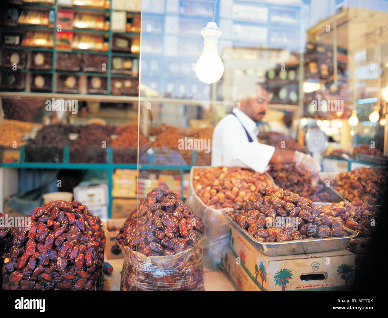 Merchant arranging his dates on display in his shop in Bab Makkah
