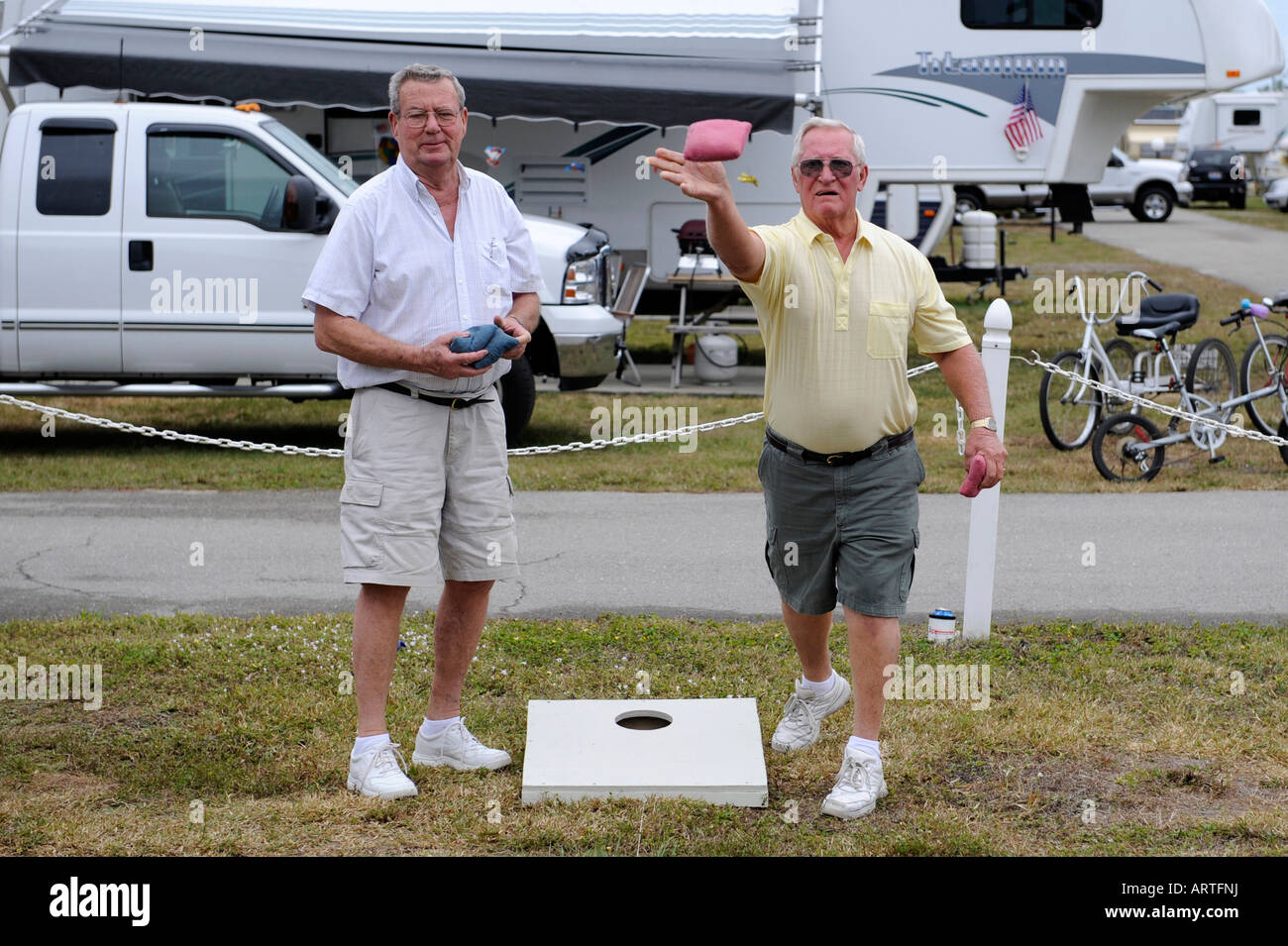 Senior retired citizens play game of bean bag toss in a recreational