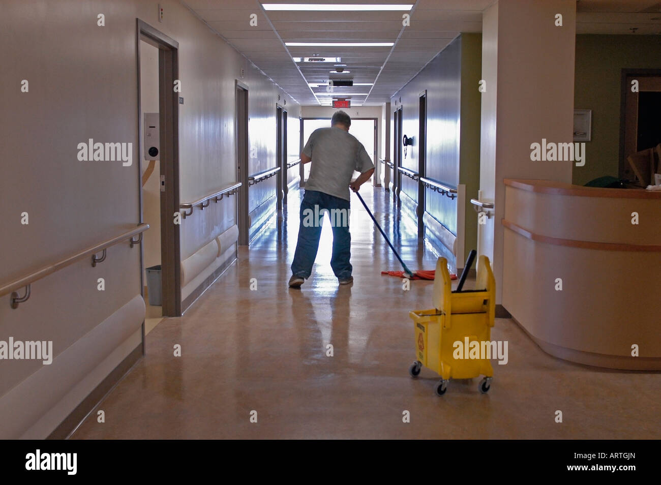 A housekeeping employee mops the floor of a modern hospital Stock Photo Alamy