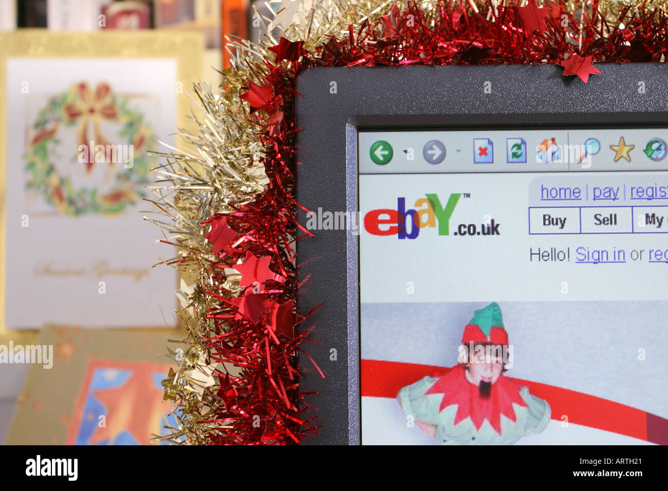 A computer screen decorated with tinsel displaying a Christmas-themed page from the ebay web site. 2005 Stock Photo
