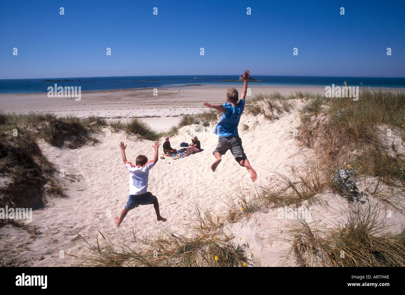 Boys jumping off sand dune,Jersey, Channel Islands Stock Photo Alamy