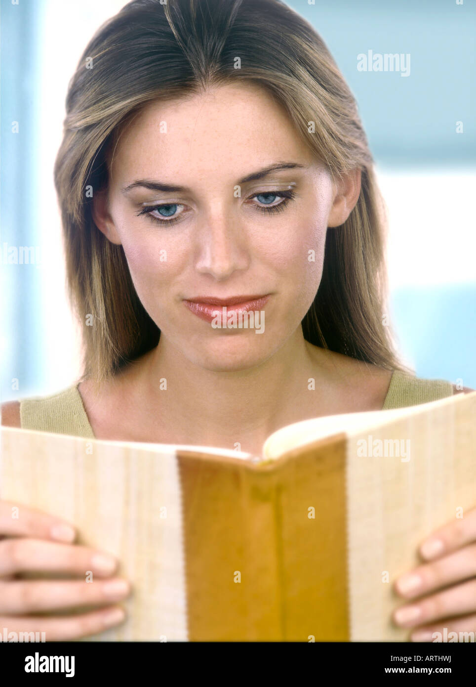 A woman reading her thoughts in her diary Stock Photo