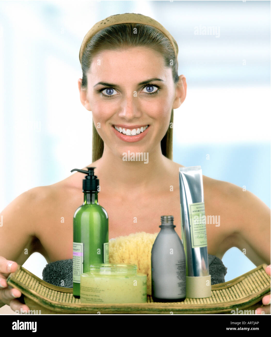 A woman holding a tray filled with beauty products Stock Photo