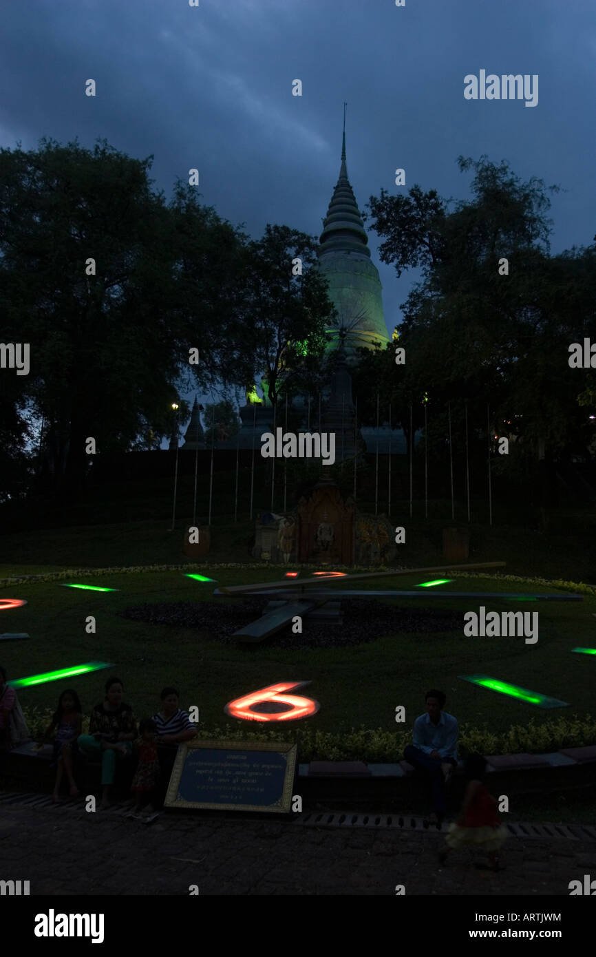 Clock in front of Wat Phnom at night Phnom Penh Cambodia Stock Photo
