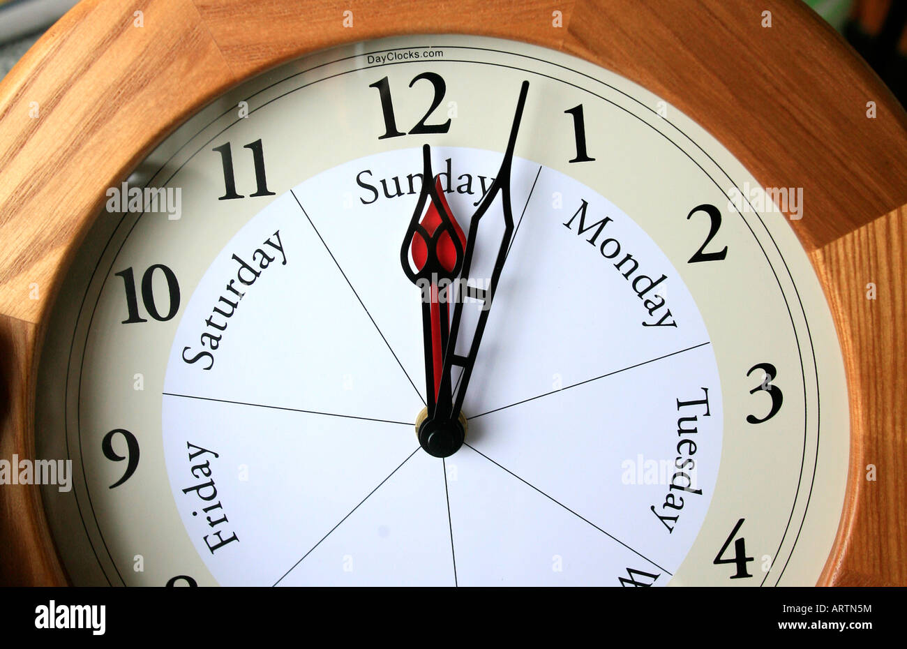 A dayclock shows the day of the week as well as time of day Stock Photo