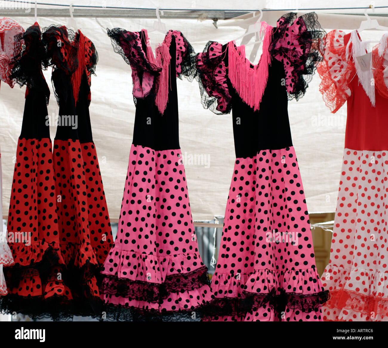 Four traditional Spanish dresses on display on stall in Costa Blanca