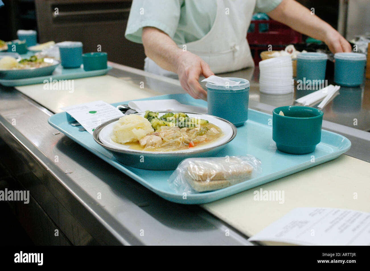 The assembly of the food trays on a conveyor belt in the dietary