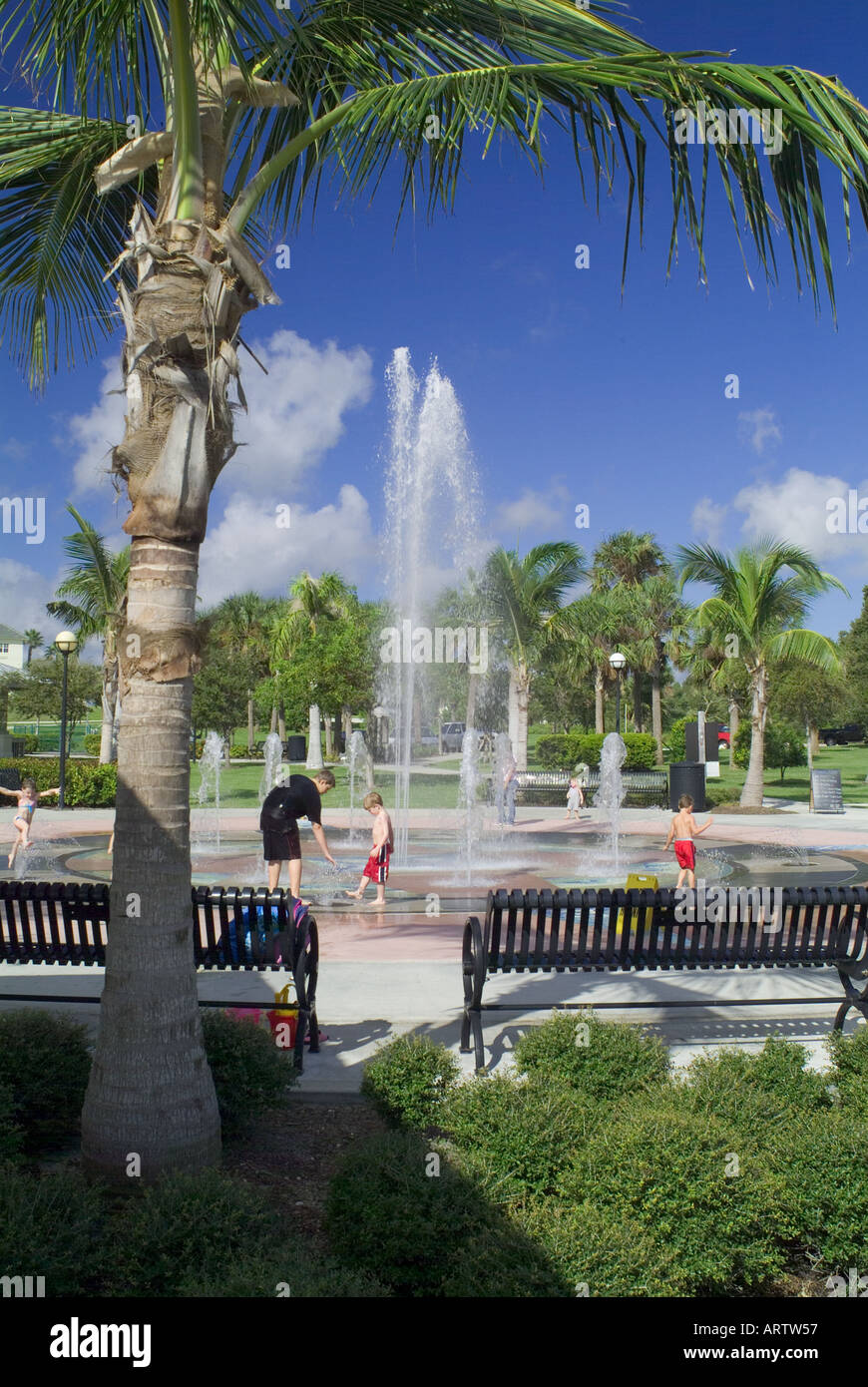 children playing in water fountain at a Florida park cooling off recreation fun wet fountains Stock Photo