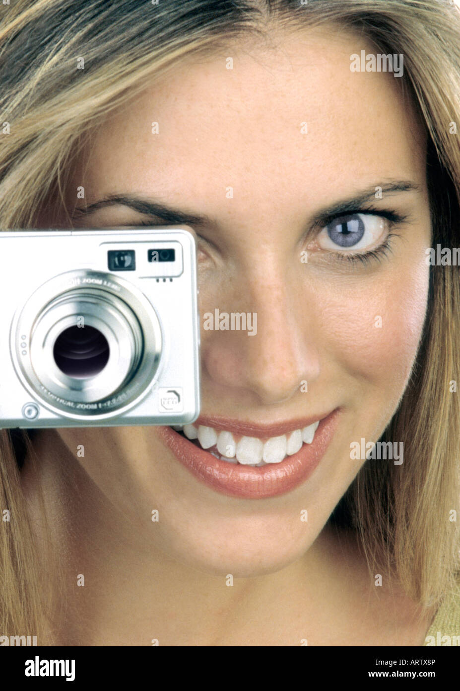 A woman looking through a point and shoot camera Stock Photo