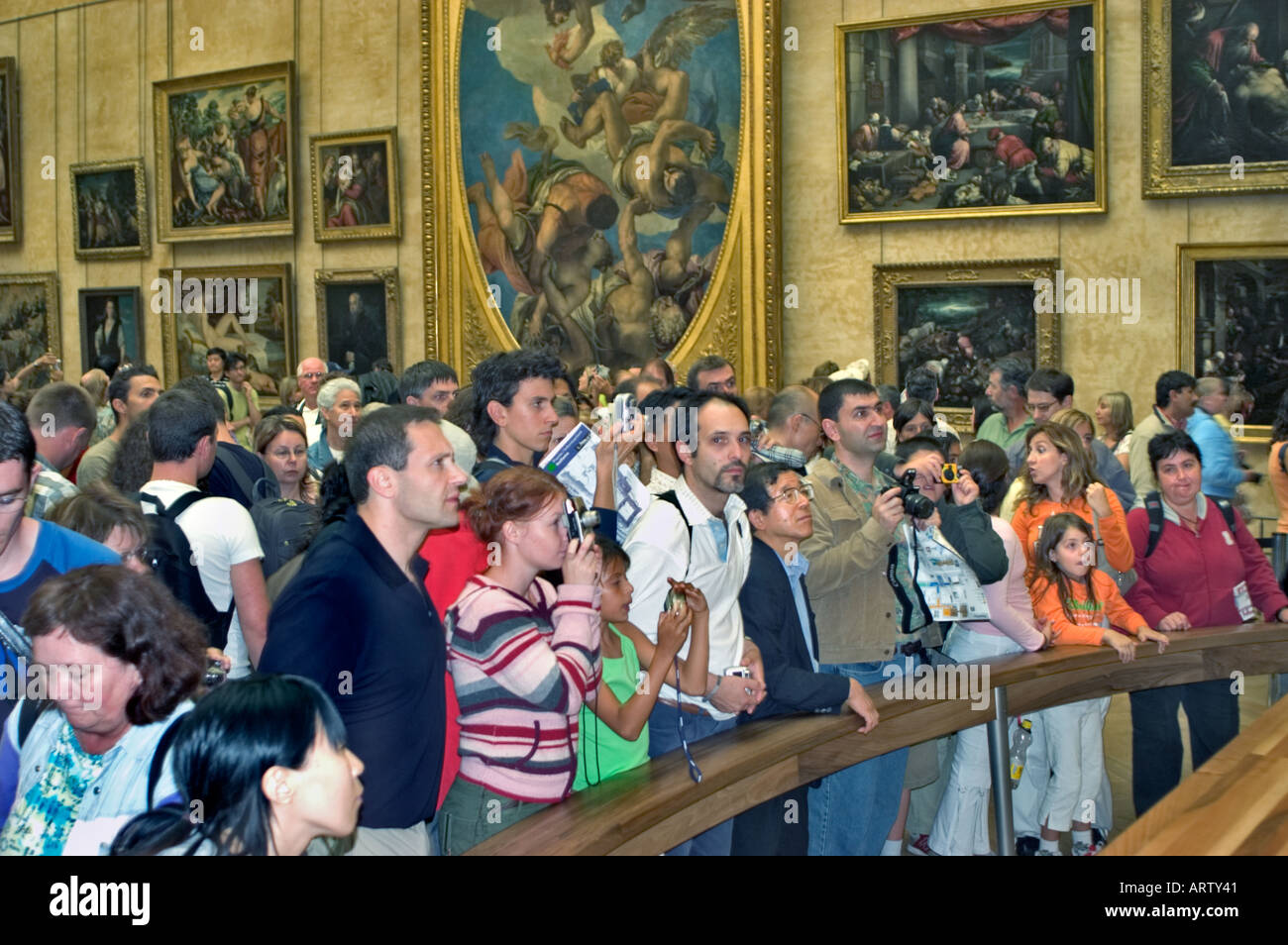 Paris France, Crowd Tourists Looking Photographing Leonardo Da Vinci's 'Mona Lisa' Art Painting inside Louvre Museum, art museum with kids, children Stock Photo