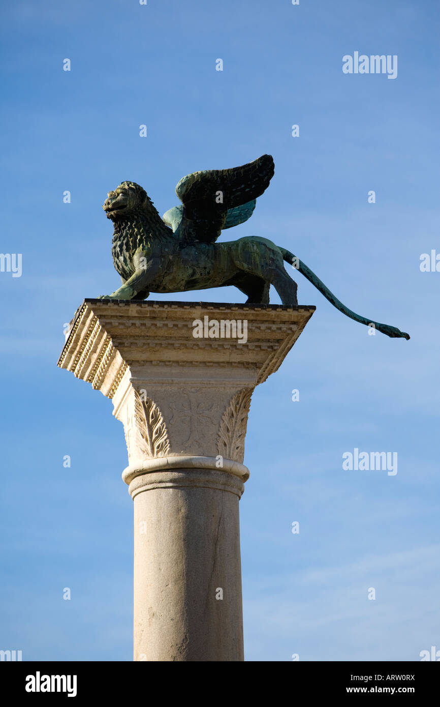 The winged lion, the symbol of Venice Italy sits atop a column at the entrance to St Mark's