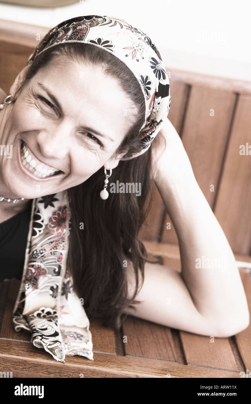 Portrait of a mid adult woman lying on a bench and smiling Stock Photo ...
