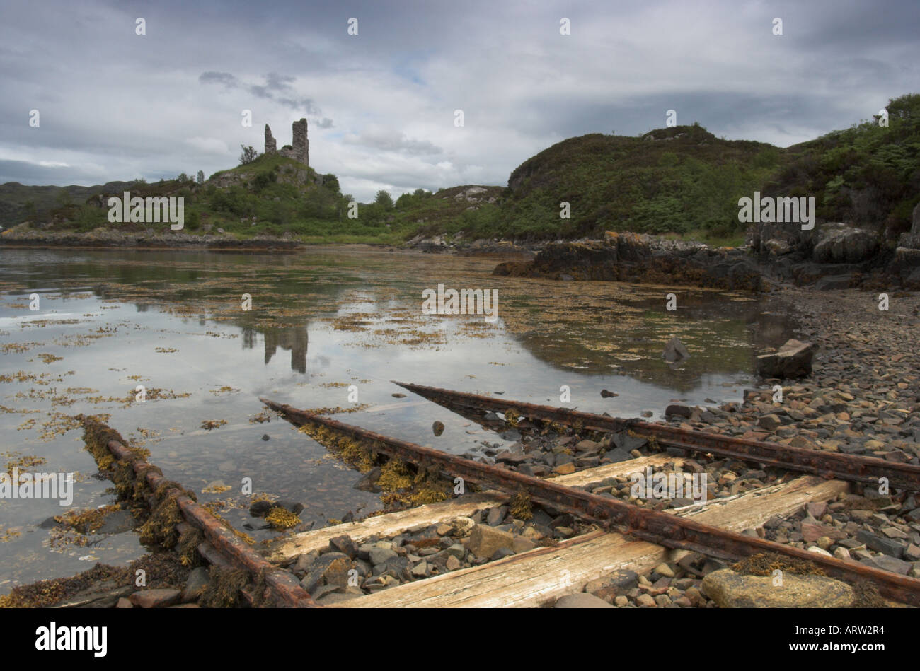 landscape photo of castle moil at Kyleakin on the Isle of Skye in Scotland with rails in the foreground Stock Photo