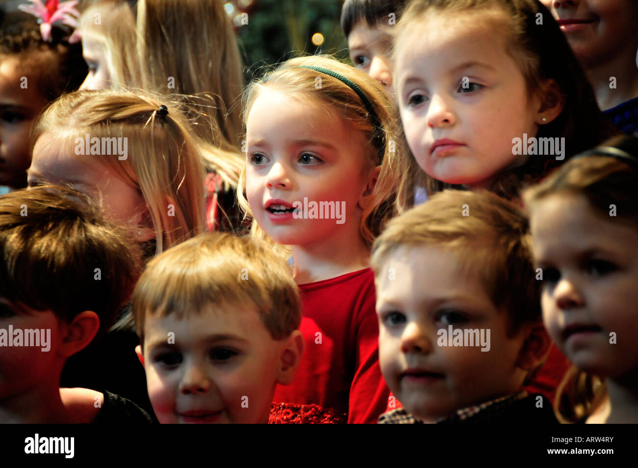 4 four year old pre school children hold recital performance for parents Stock Photo