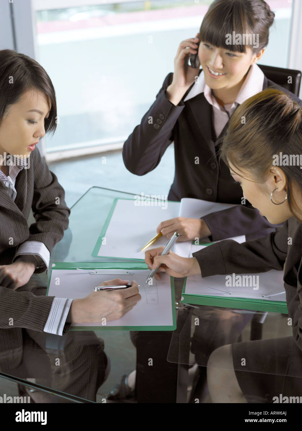 Three Businesswomen in a Meeting Stock Photo - Alamy