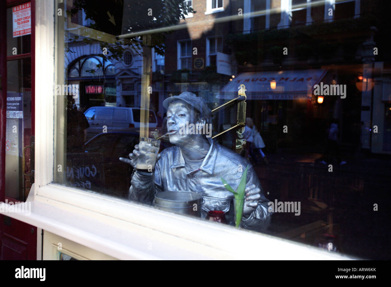 united kingdom west london covent garden a silver street performer in
