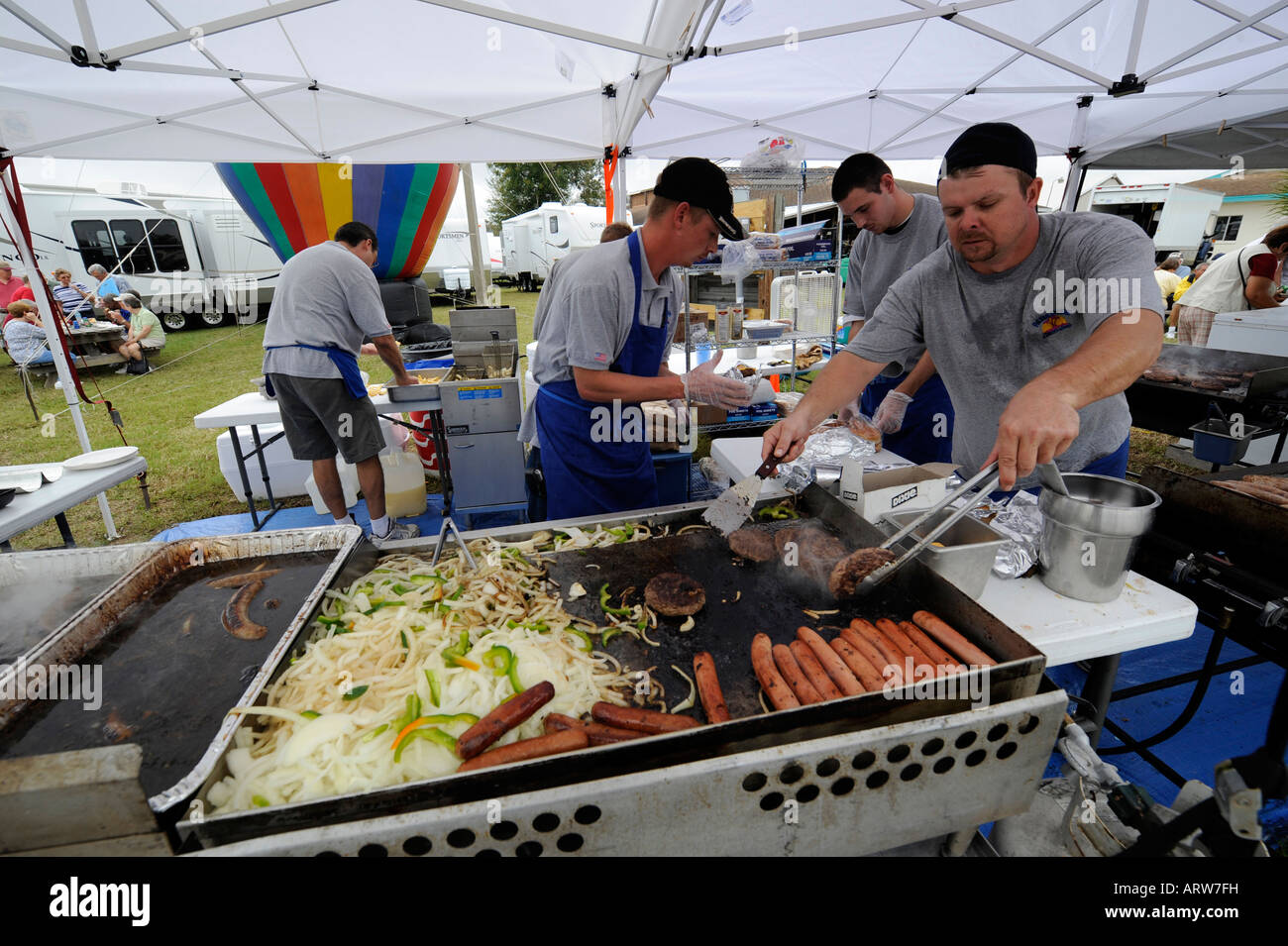 Hot dog and hamburger preparation on a grill at a festival in Naples Florida Stock Photo
