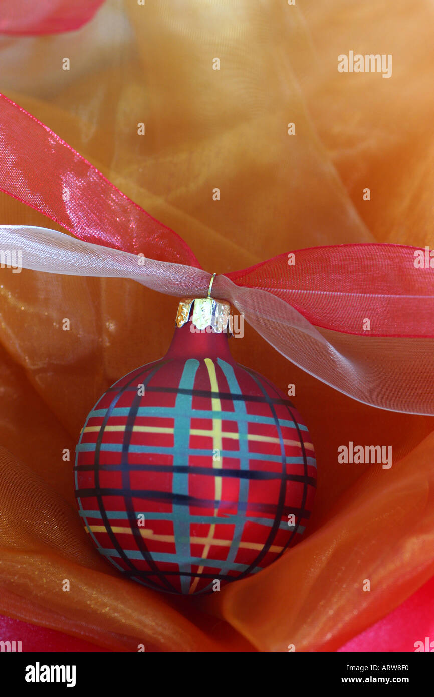 Plaid Christmas ornament against a silky background Stock Photo