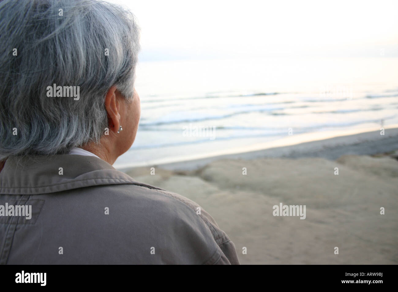 elderly woman looking out at ocean, southern california Stock Photo