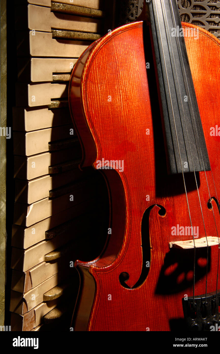 Violin and an old broken Accordion Stock Photo Alamy