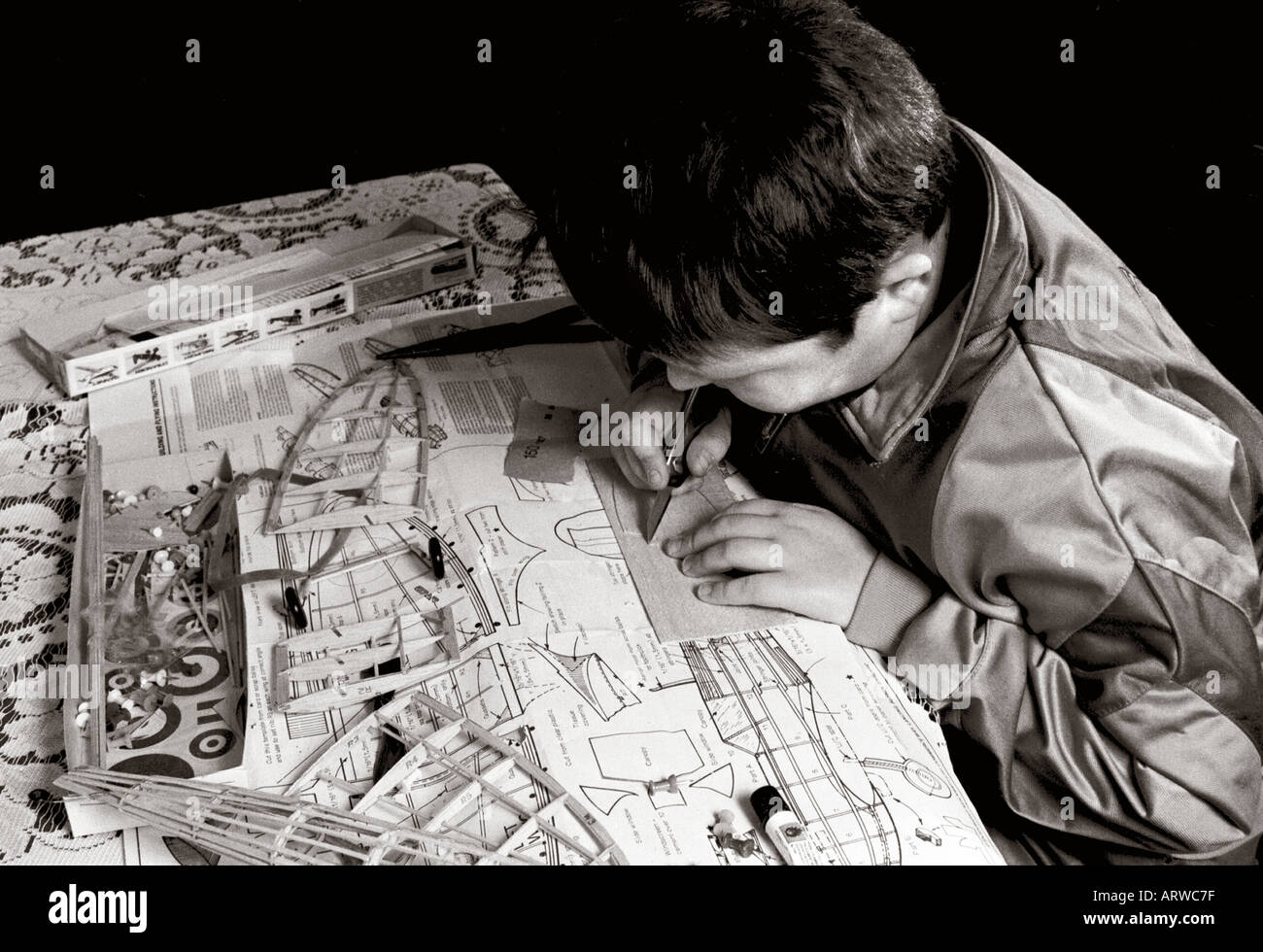 Boy working on flying model aircraft kit Stock Photo