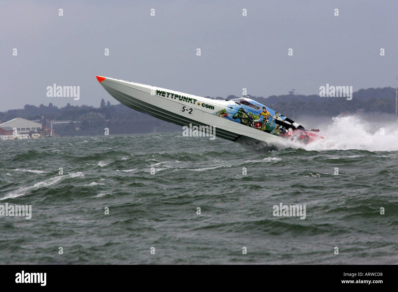 Power Boat lifting out of the water in choppy seas Stock Photo