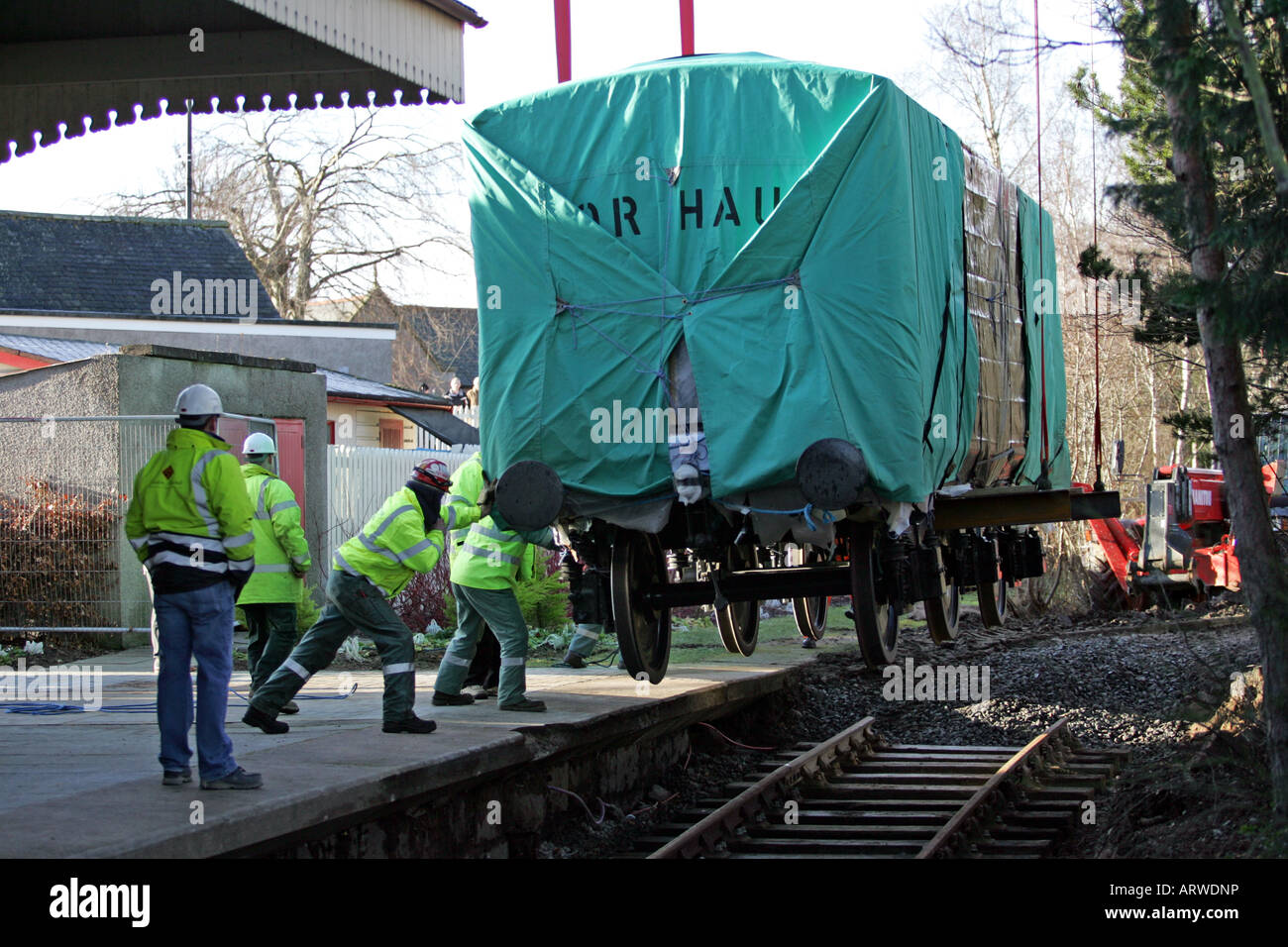 A replica of the Royal railway carriage used by Queen Victoria to travel to Balmoral is lifted by crane into place at Ballater Stock Photo